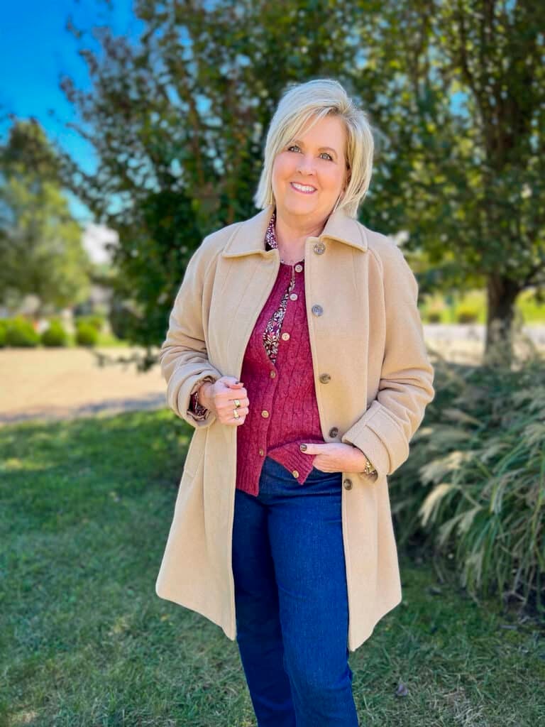 Over 40 Fashion Blogger, Tania Stephens is wearing a sweater with a floral top and jeans from Appleseeds18