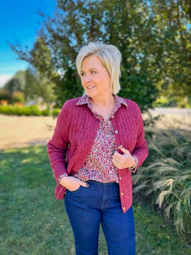 Over 40 Fashion Blogger, Tania Stephens is wearing a sweater with a floral top and jeans from Appleseeds4