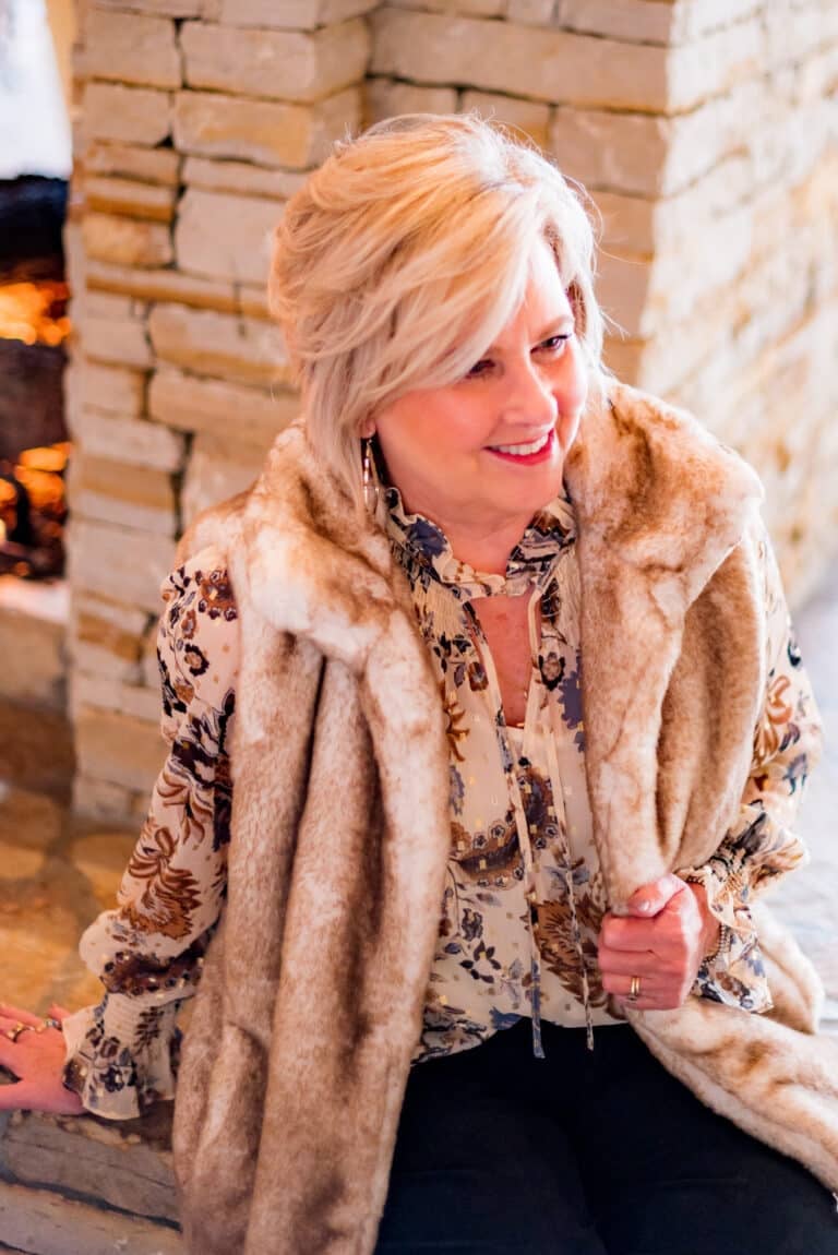 Over 40 Fashion Blogger, Tania Stephens is wearing a leaf print blouse with a fur vest and black pants1057
