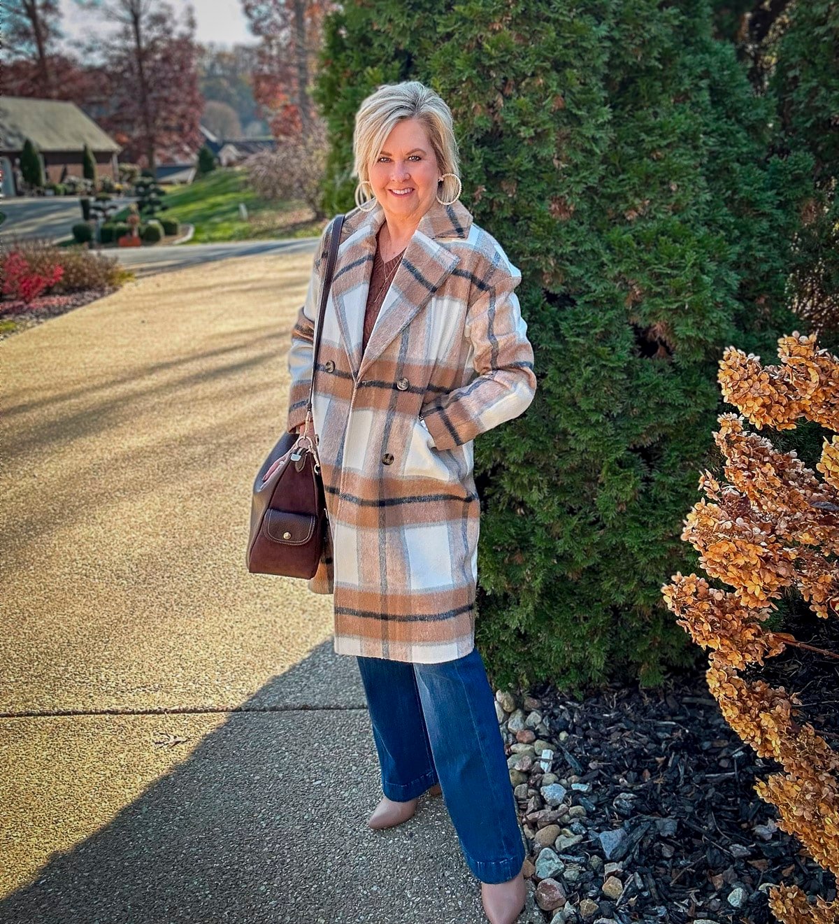 Over 40 Fashion Blogger, Tania Stephens is wearing a sweater and jeans outfit for fall16