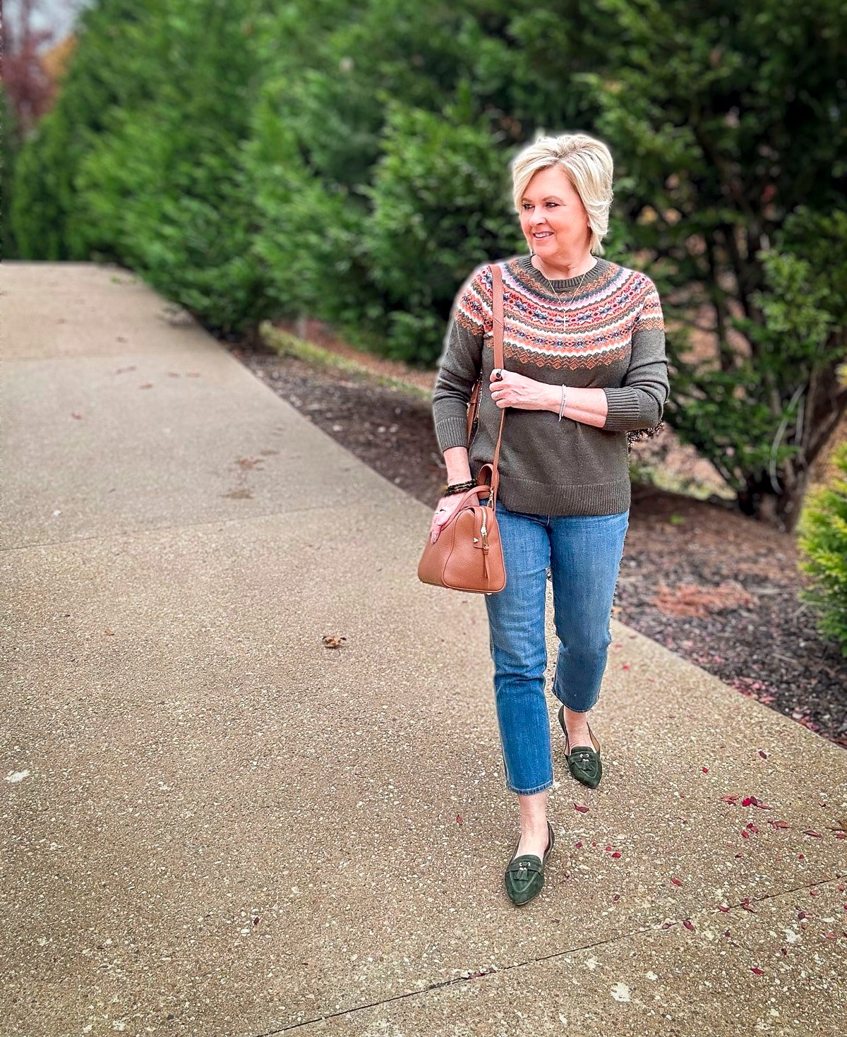 Over 40 Fashion Blogger, Tania Stephens is wearing an olive Fairisle sweater with ankle jeans 13