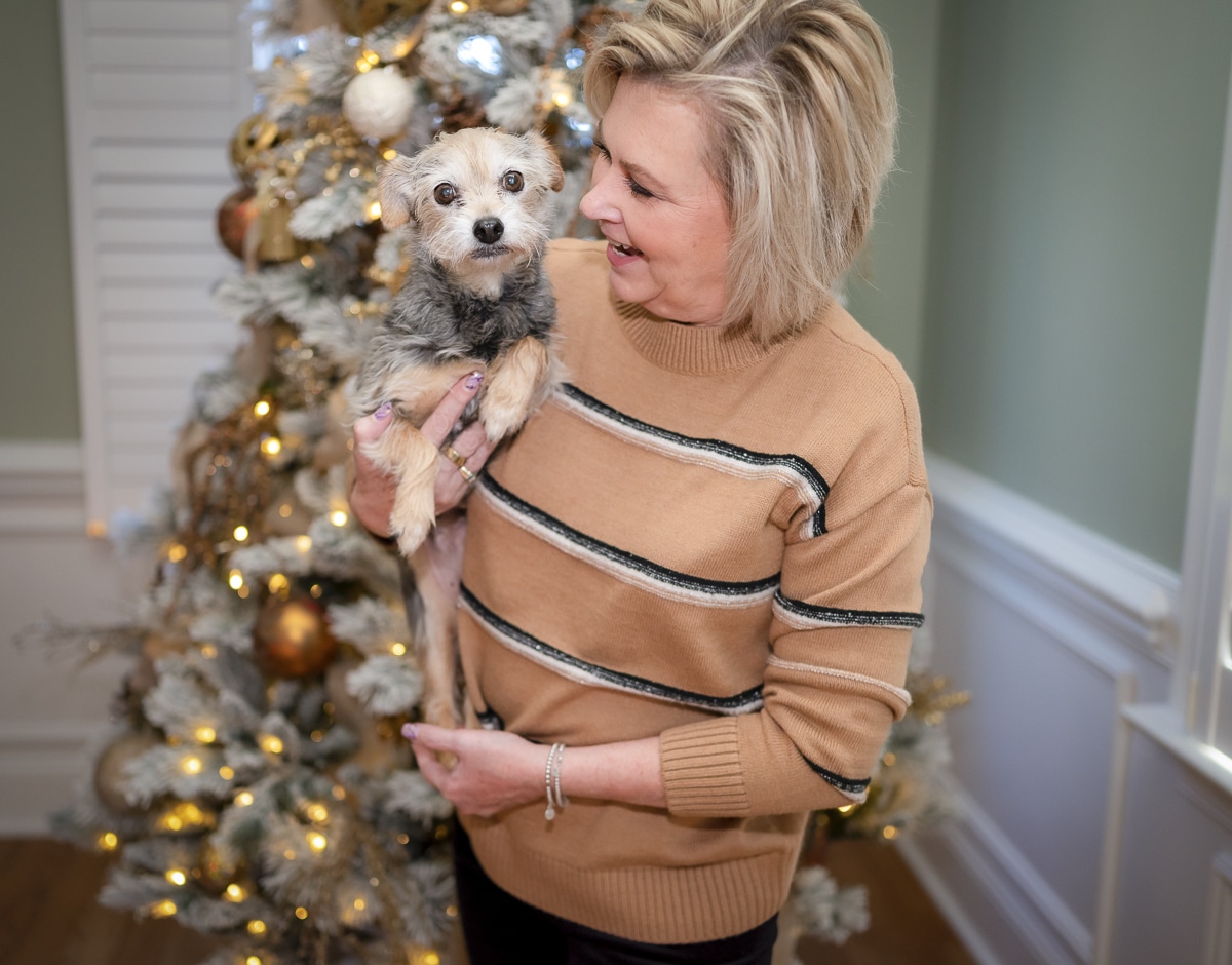 Over 40 Fashion Blogger, Tania Stephens is wearing a camel and black striped sweater with black pants 11