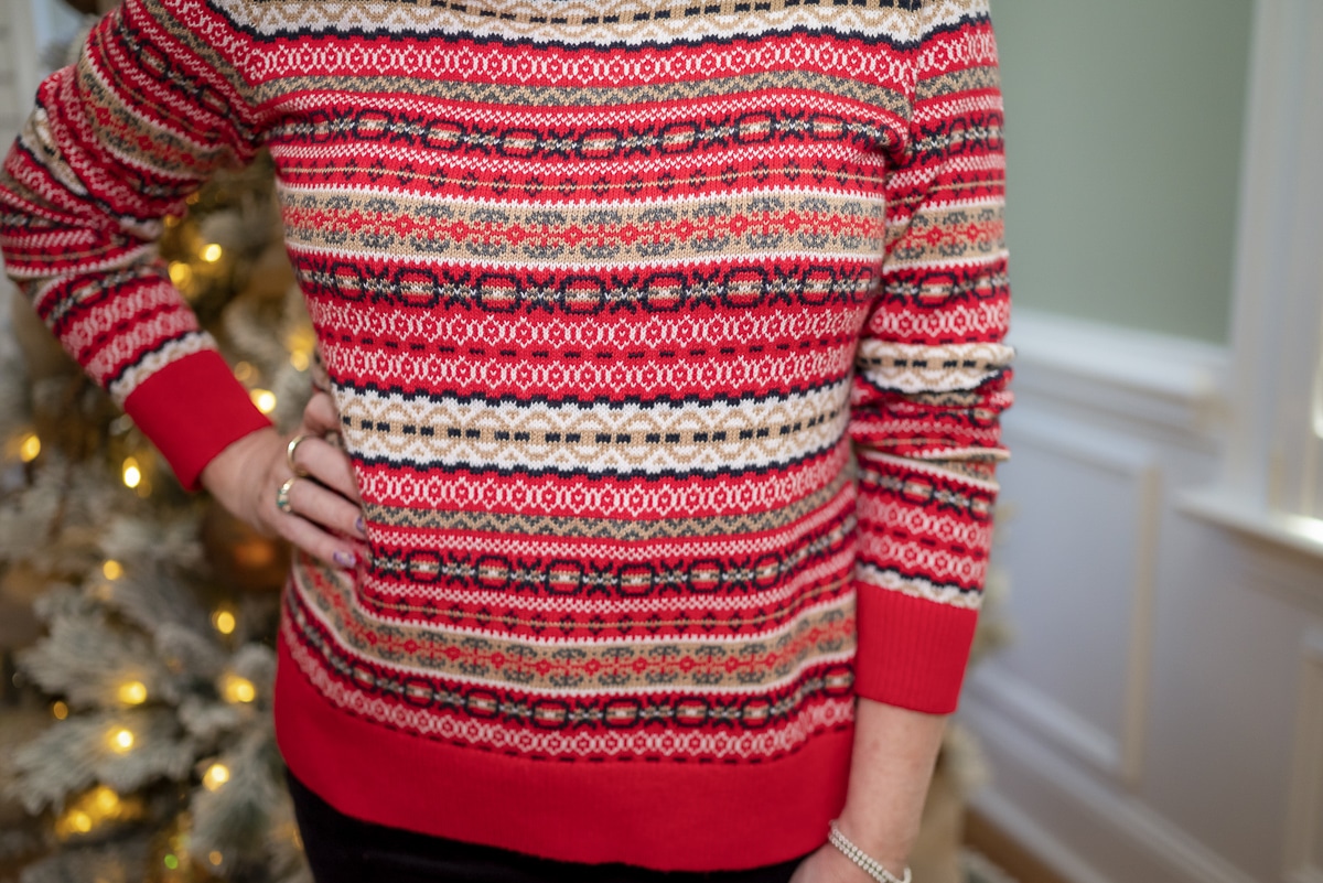 Over 40 Fashion Blogger, Tania Stephens is wearing a red Fairisle sweater with black pants 9