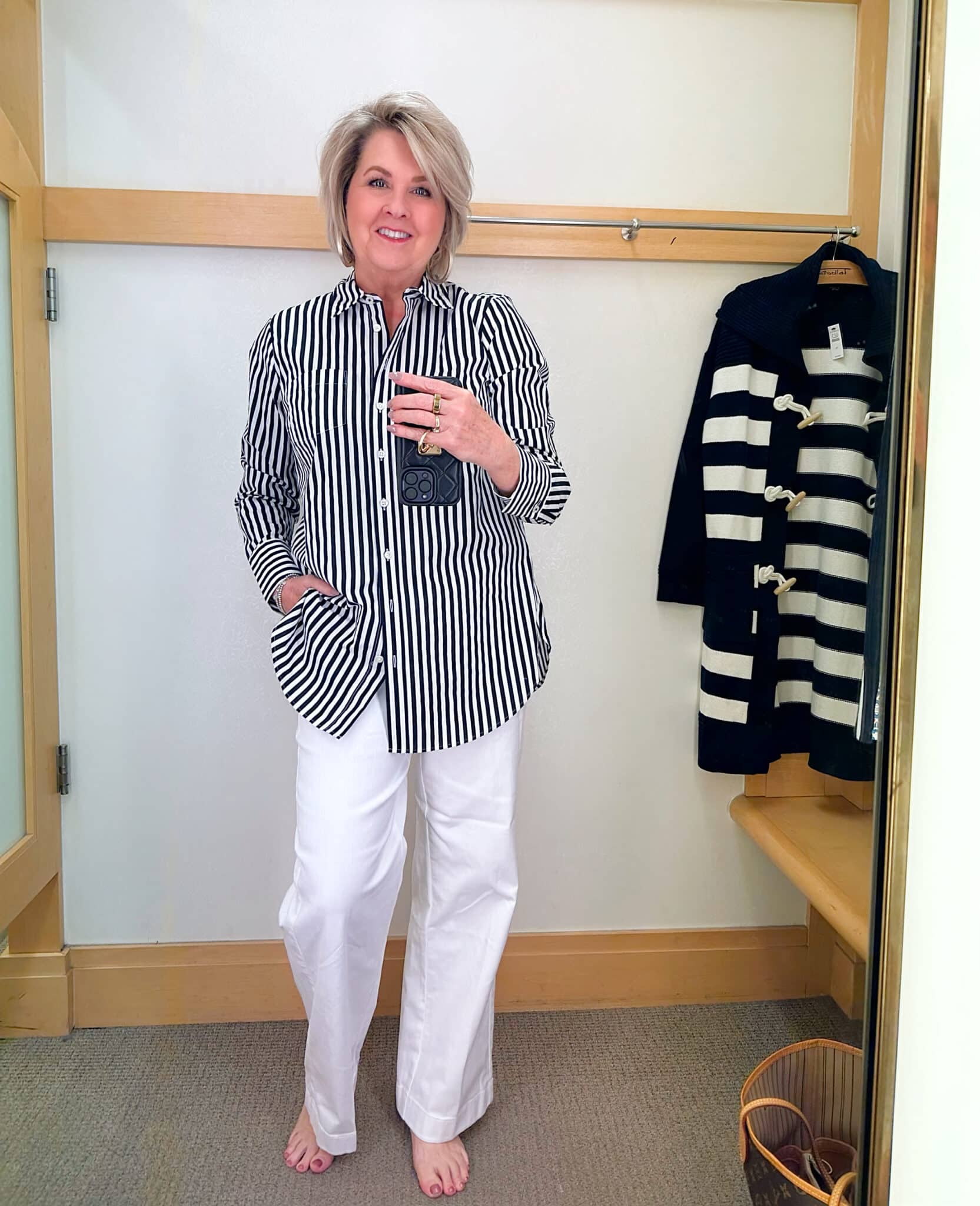 Tania Stephens from 50 Is Not Old is styling a black and white striped top with white wide leg pants from Talbots