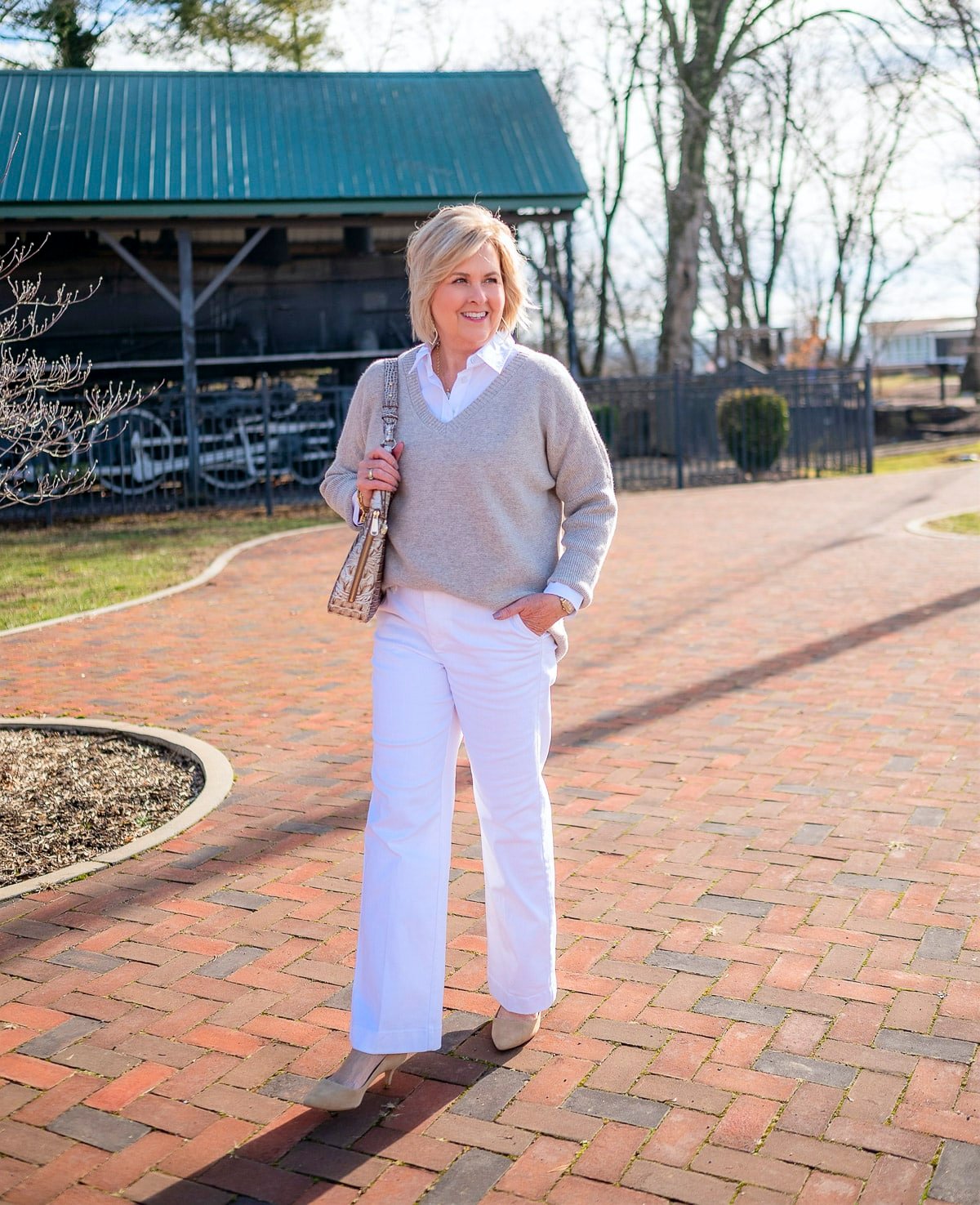 50 Is Not Old is wearing white wide leg pants and a cashmere sweater and is casual elegance 2