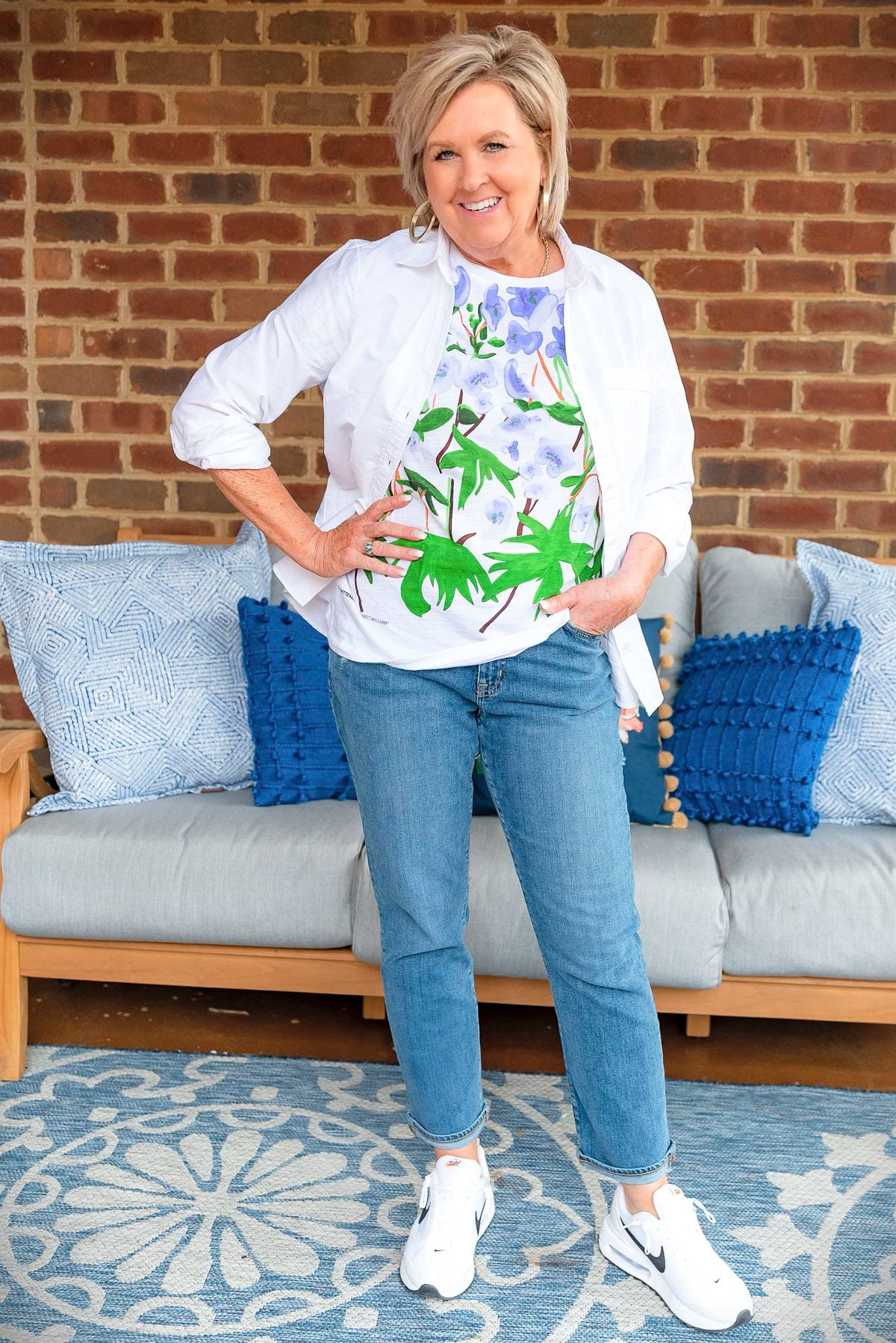 Fashion Blogger, 50 Is Not Old is showing ways to style a white button up shirt with jeans and a graphic tee 27