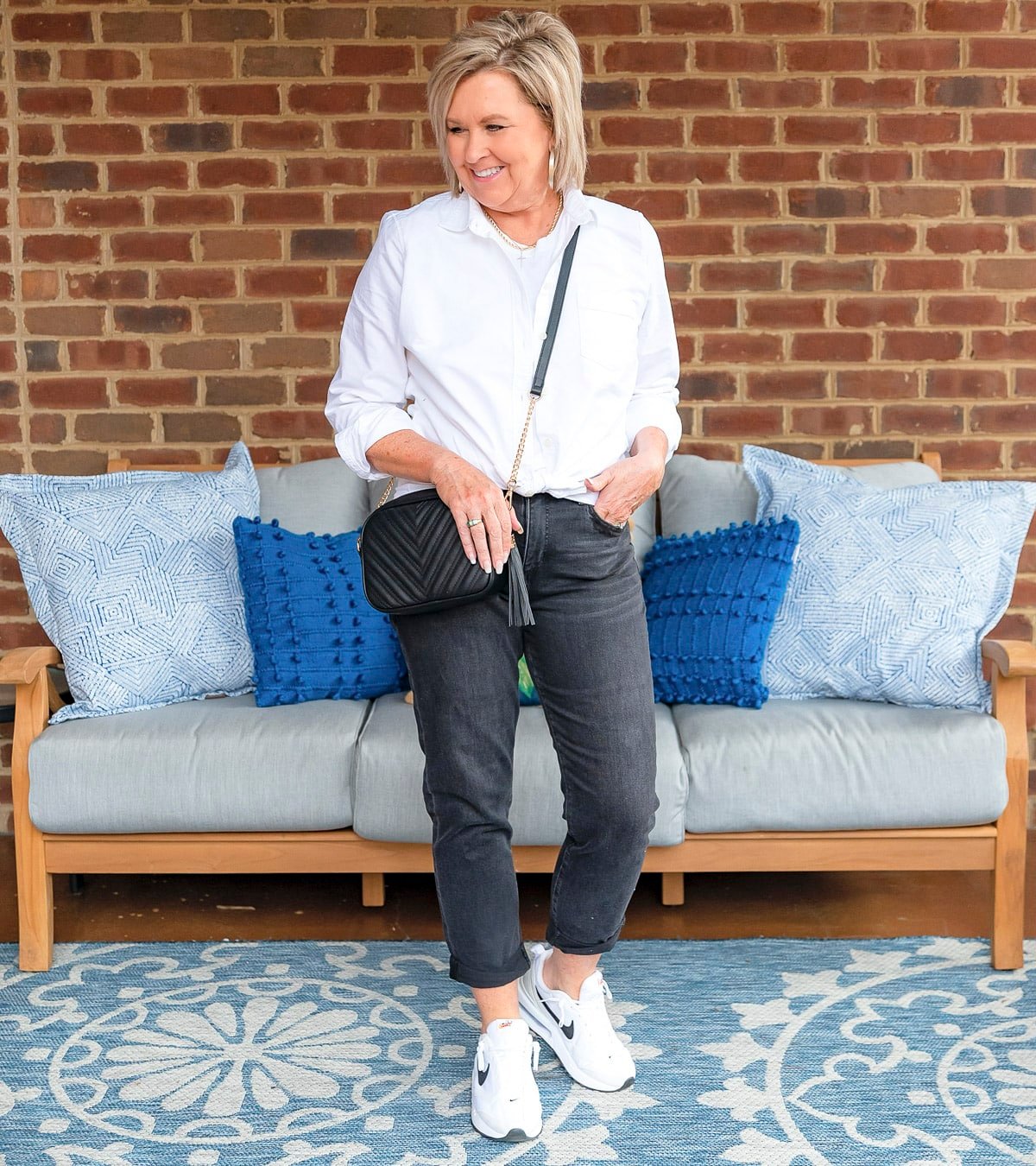 Fashion Blogger, 50 Is Not Old is showing ways to style a white button up shirt with black jeans 32