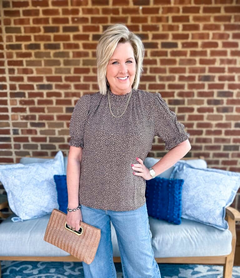 Tania Stephens is wearing a casual leopard print outfit with wide leg jeans and a black blazer16