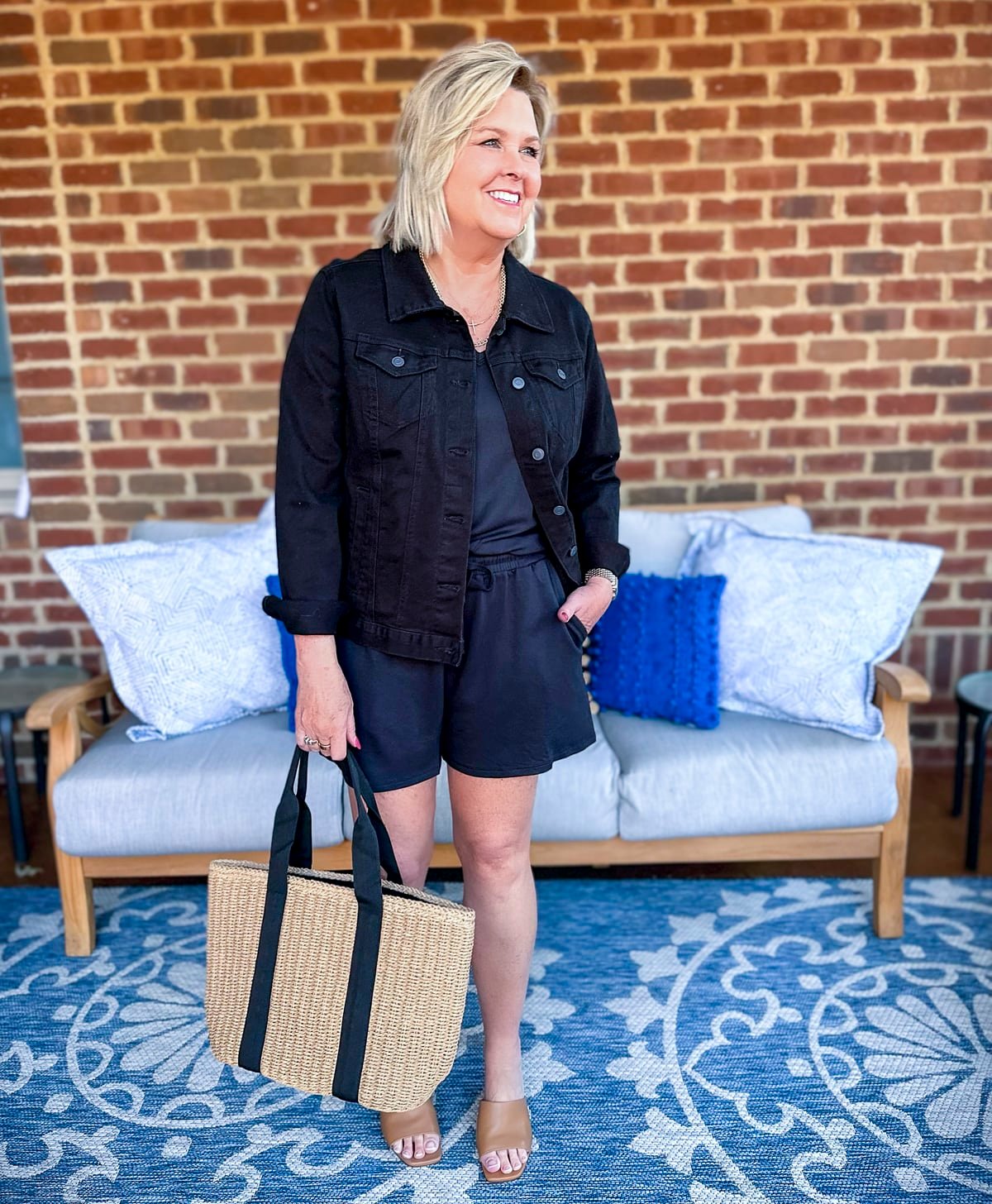 Tania Stephens is showing how colored denim jackets for women over 50 looks great with a romper