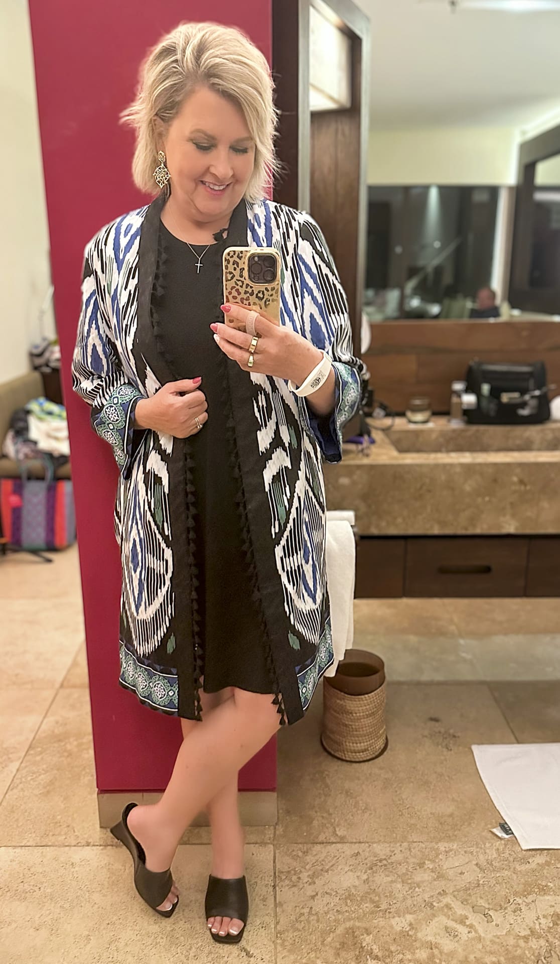 Tania Stephens is wearing a black tank dress with a Kimono