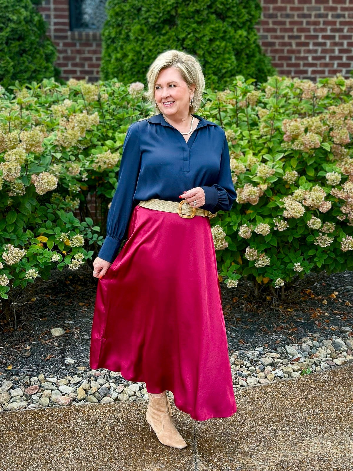 Tania Stephens is wearing navy and a pink satin midi skirt