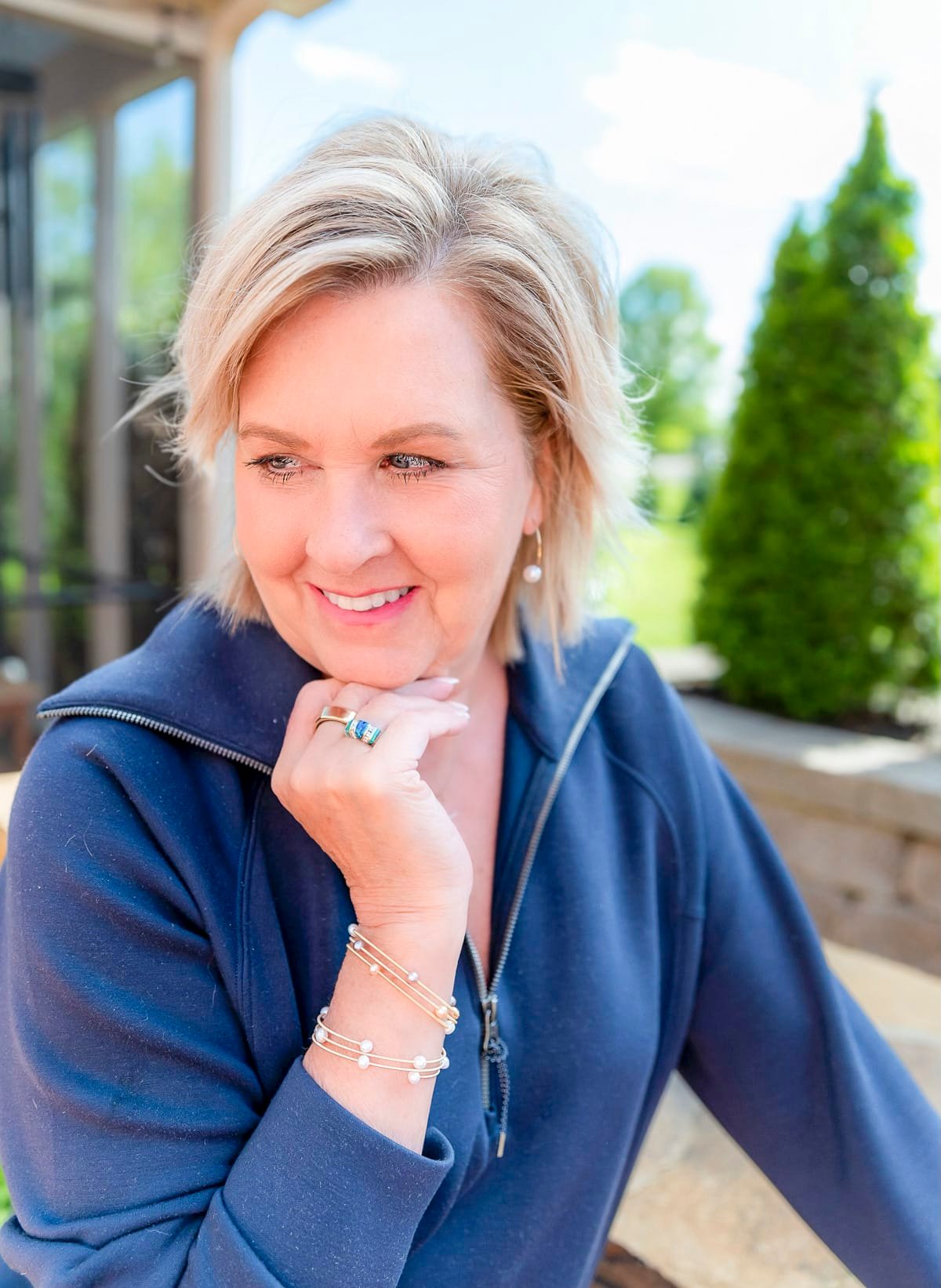 Fashion Blogger, Tania Stephens is wearing a navy top with pearl jewelry