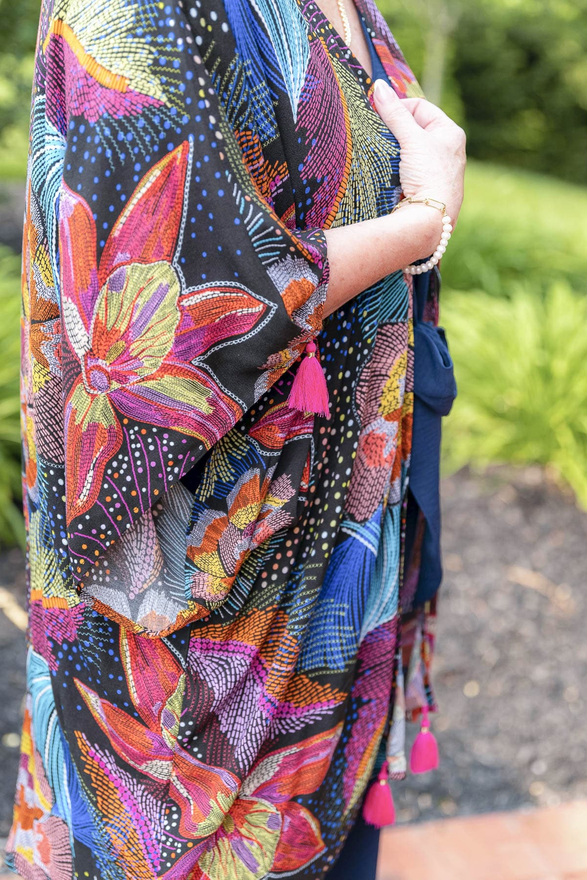 Over 50 Fashion Blogger, Tania Stephens is showing a colorful swimsuit coverup