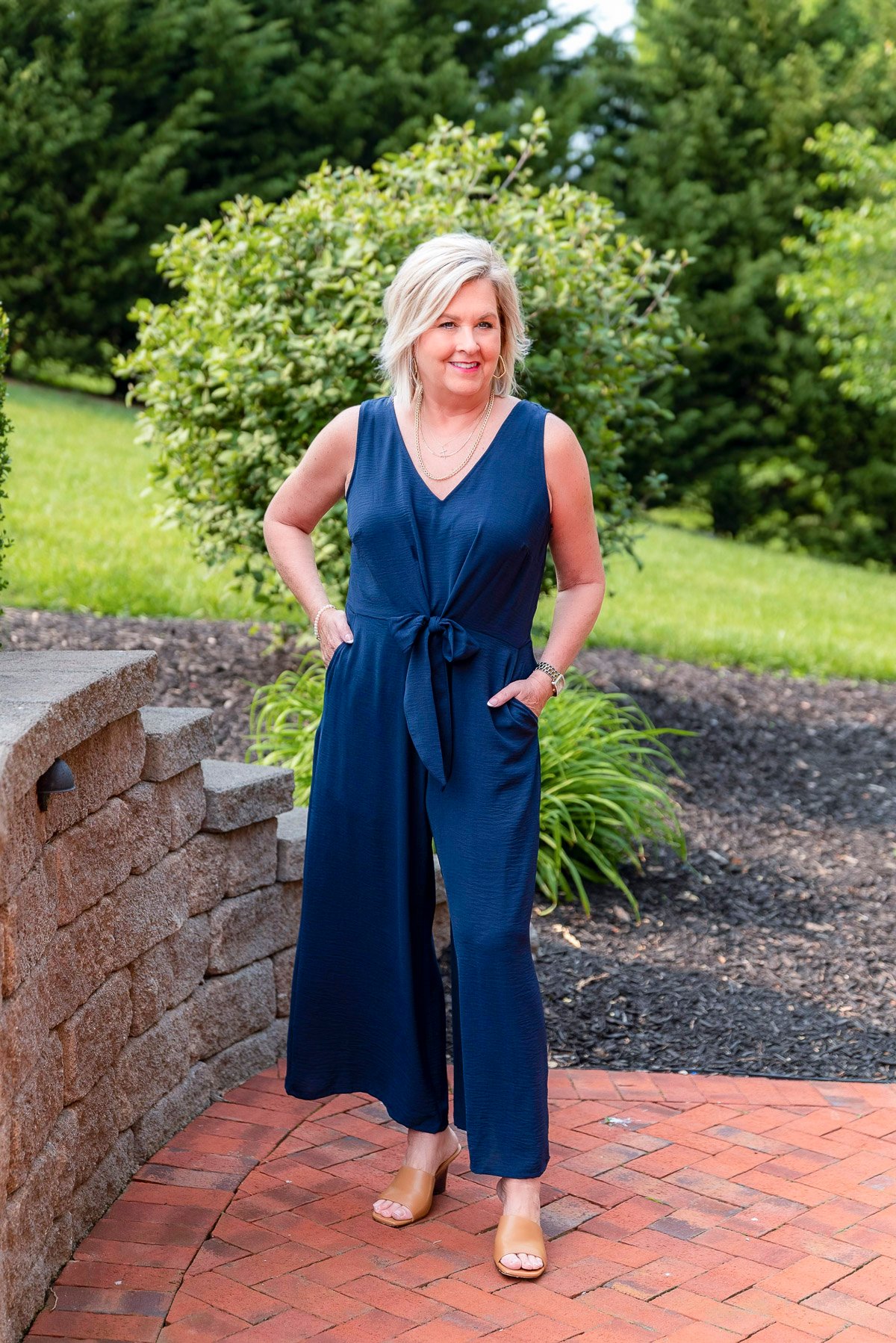 Over 50 Fashion Blogger, Tania Stephens is showing stylish ways to cover flabby arms wearing a jumpsuit 6