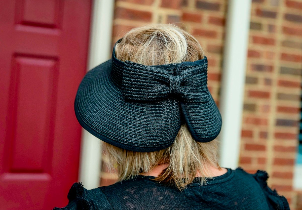 Over 50 Fashion Blogger, Tania Stephens is styling a black bow visor from Chico's