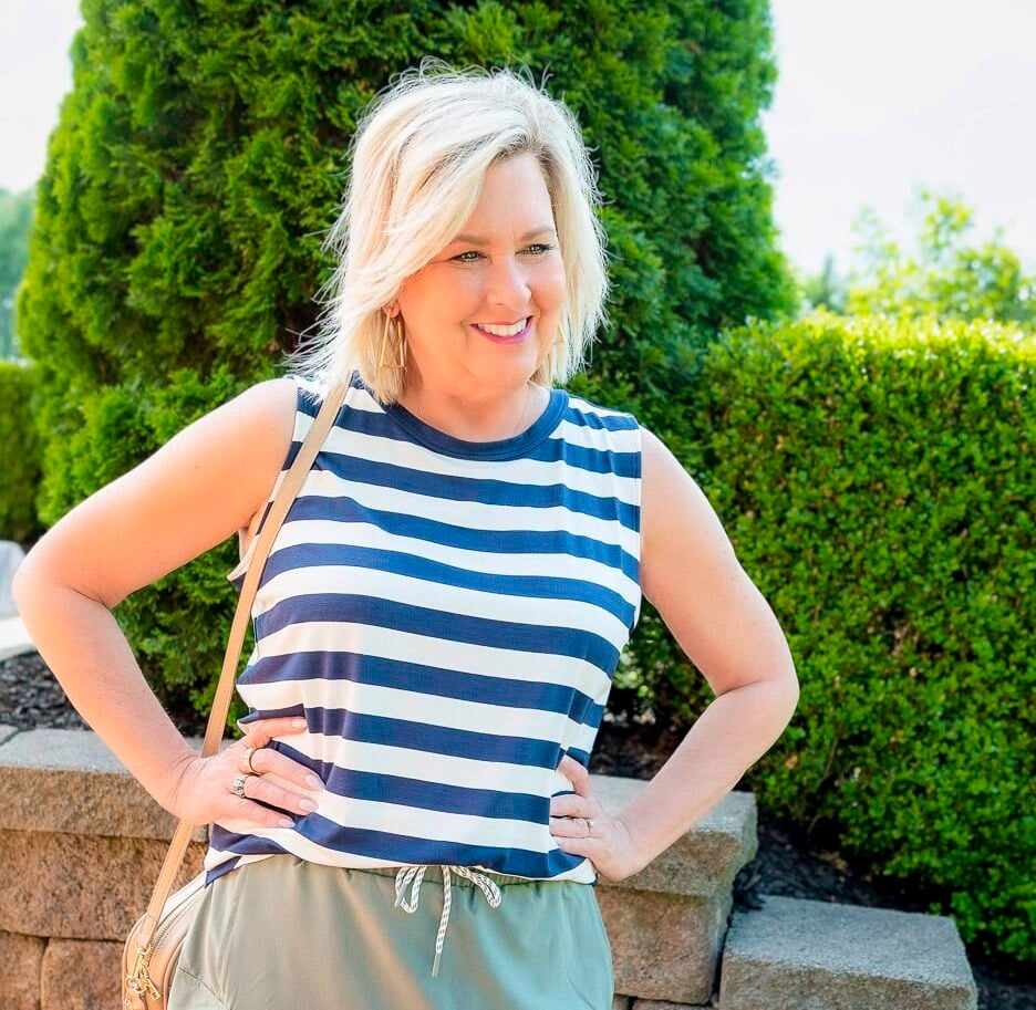 Over 50 Fashion Blogger, Tania Stephens is styling a navy and white tank with an olive skort