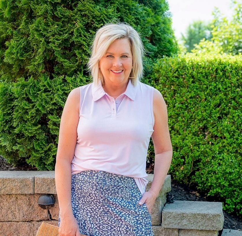 Over 50 Fashion Blogger, Tania Stephens is styling a lilac polo shirt with a skort