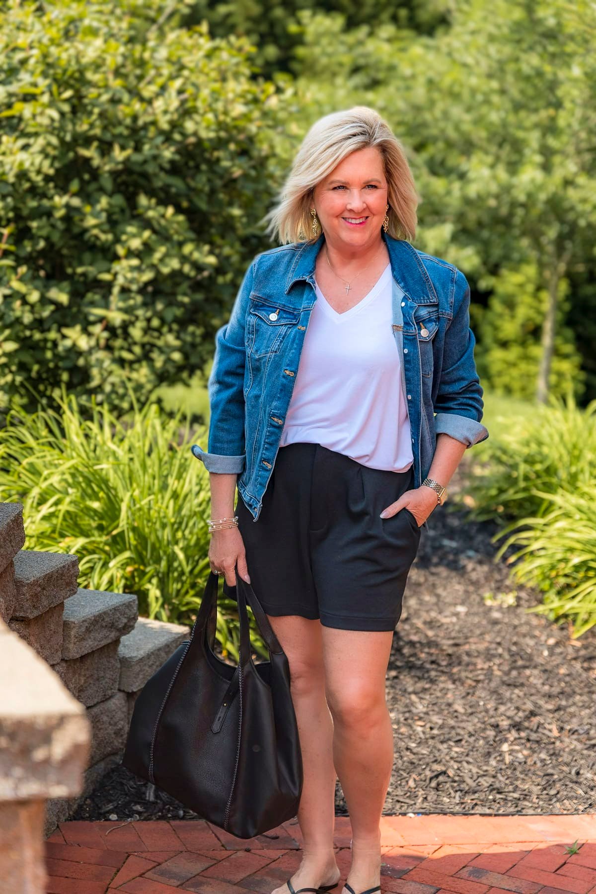 Over 50 Fashion Blogger, Tania Stephens is wearing black shorts with a denim jacket from Walmart14
