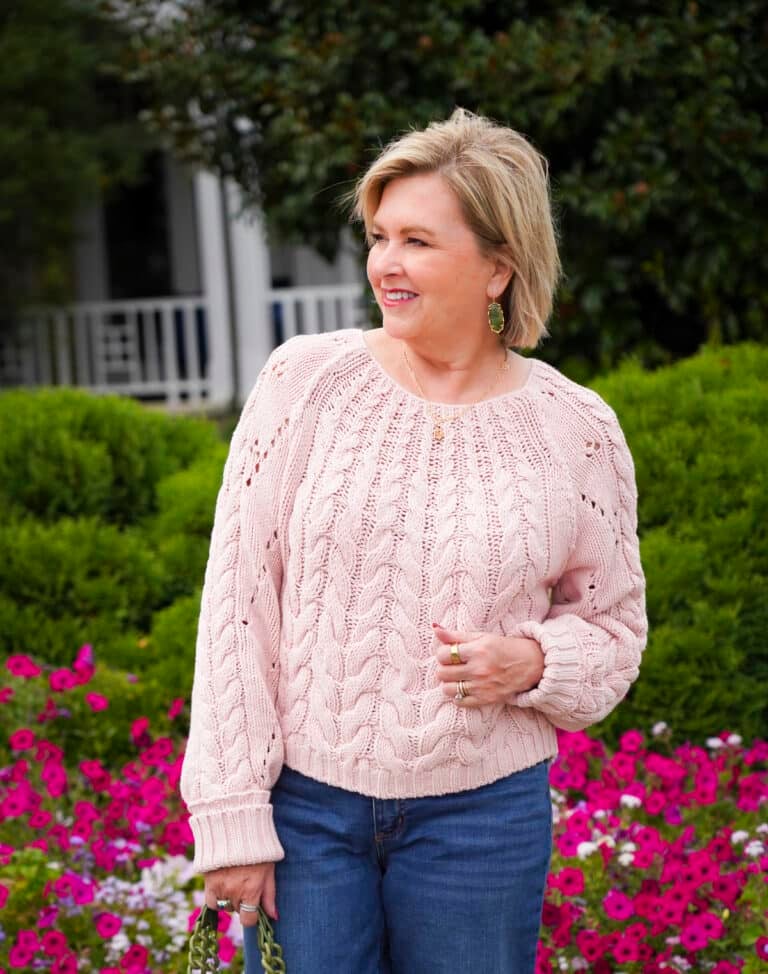 Tania Stephens is wearing a light pink knit sweater from Free People