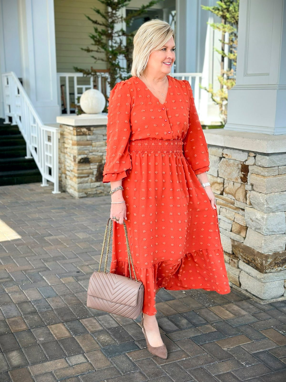 Fashion Blogger, Tania Stephens is wearing a red orange dress