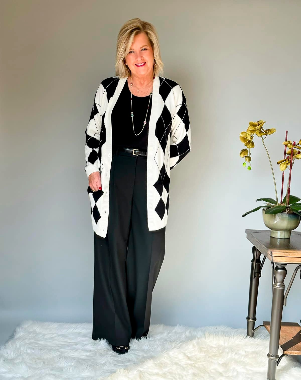 Over 50 Fashion Blogger Tania Stephens is wearing fall style ideas for women over 50 and beyond from  Talbots -  black pants, a black shell, and a argyle cardigan13