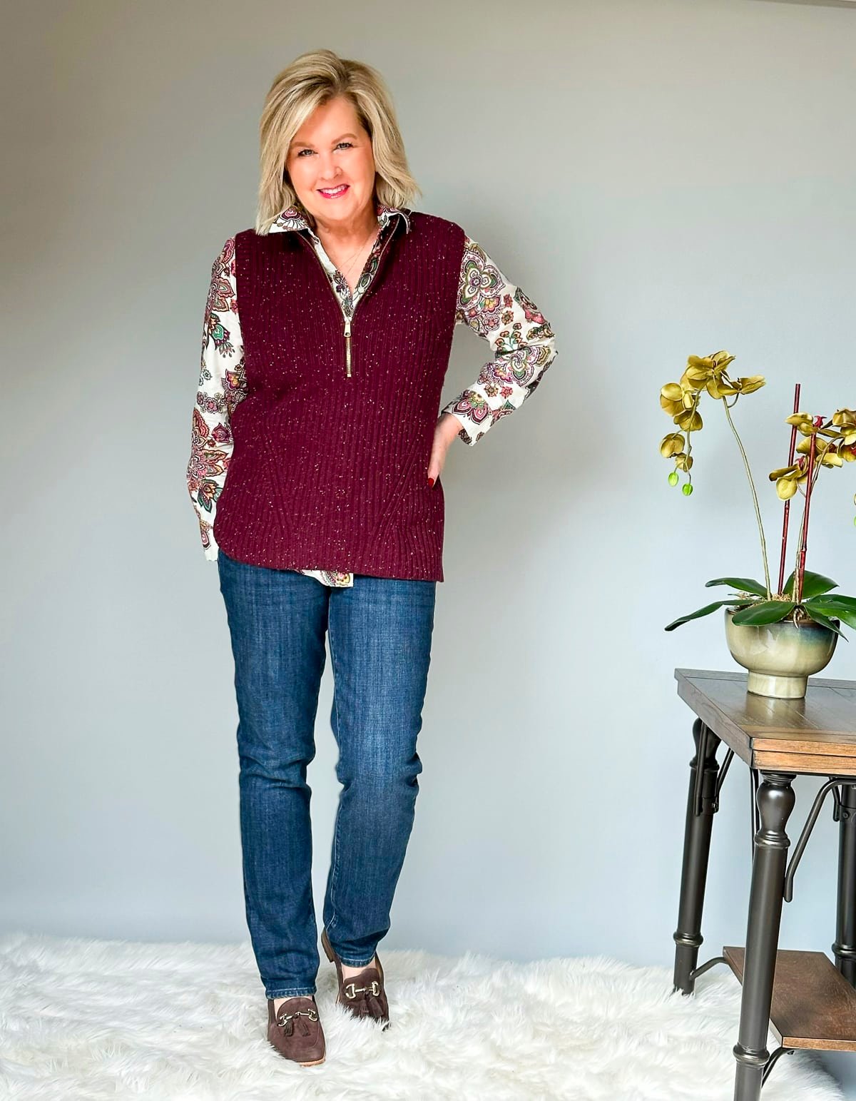 Over 50 Fashion Blogger Tania Stephens is wearing fall style ideas for women over 50 and beyond from  Talbots -  jeans, a paisley shirt, and a sweater vest