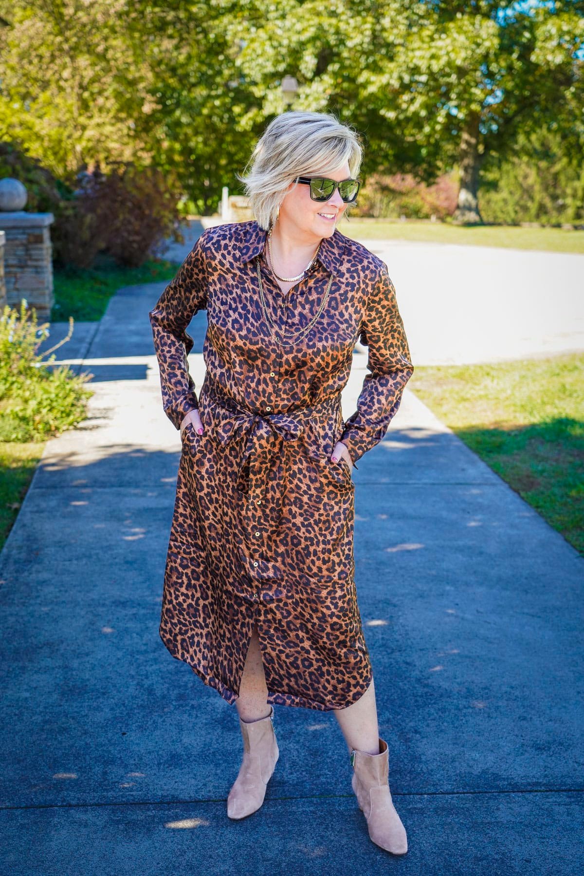 Tania Stephens is wearing a leopard midi dress with tan suede ankle bootw