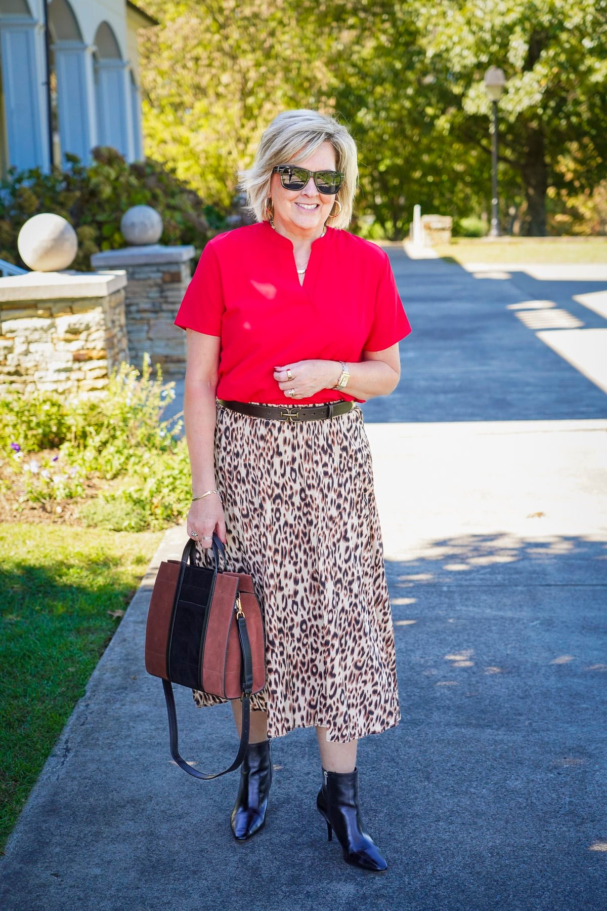 Tania Stephens is wearing a leopard pleated skirt with black ankle boots