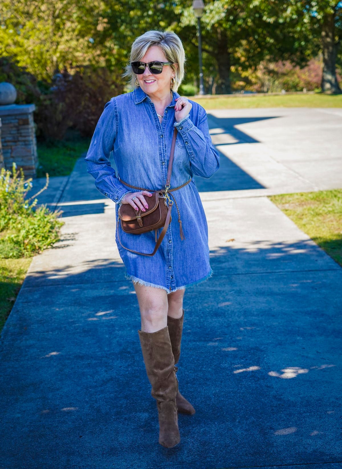 Tania Stephens is wearing a denim frayed dress with knee boots