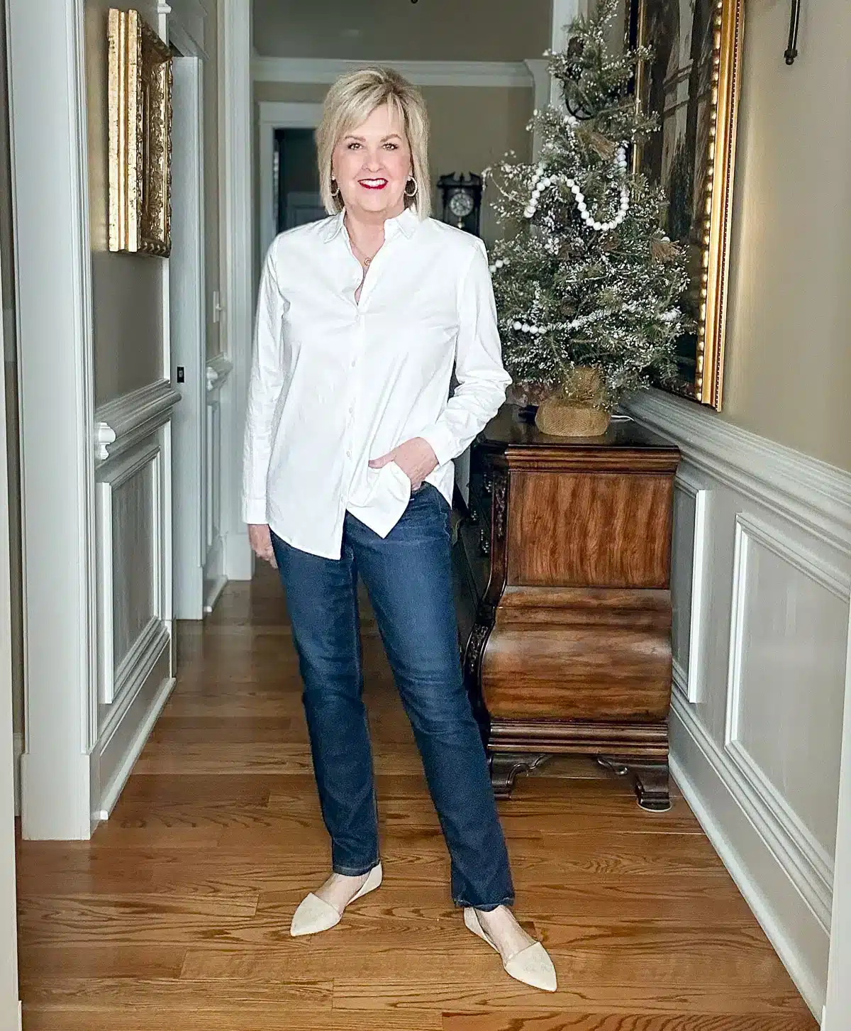 Tania Stephens styling a white long sleeve button down top.