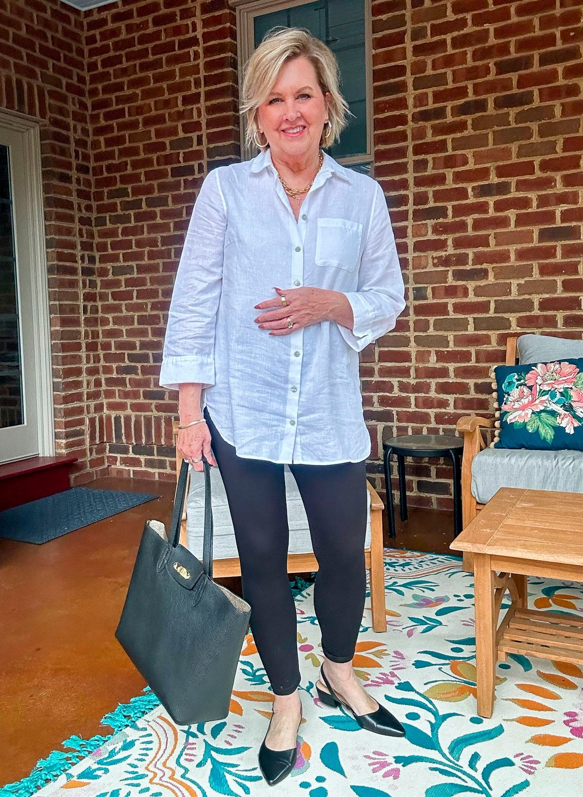 Tania Stephens wearing leggings with a white button up shirt