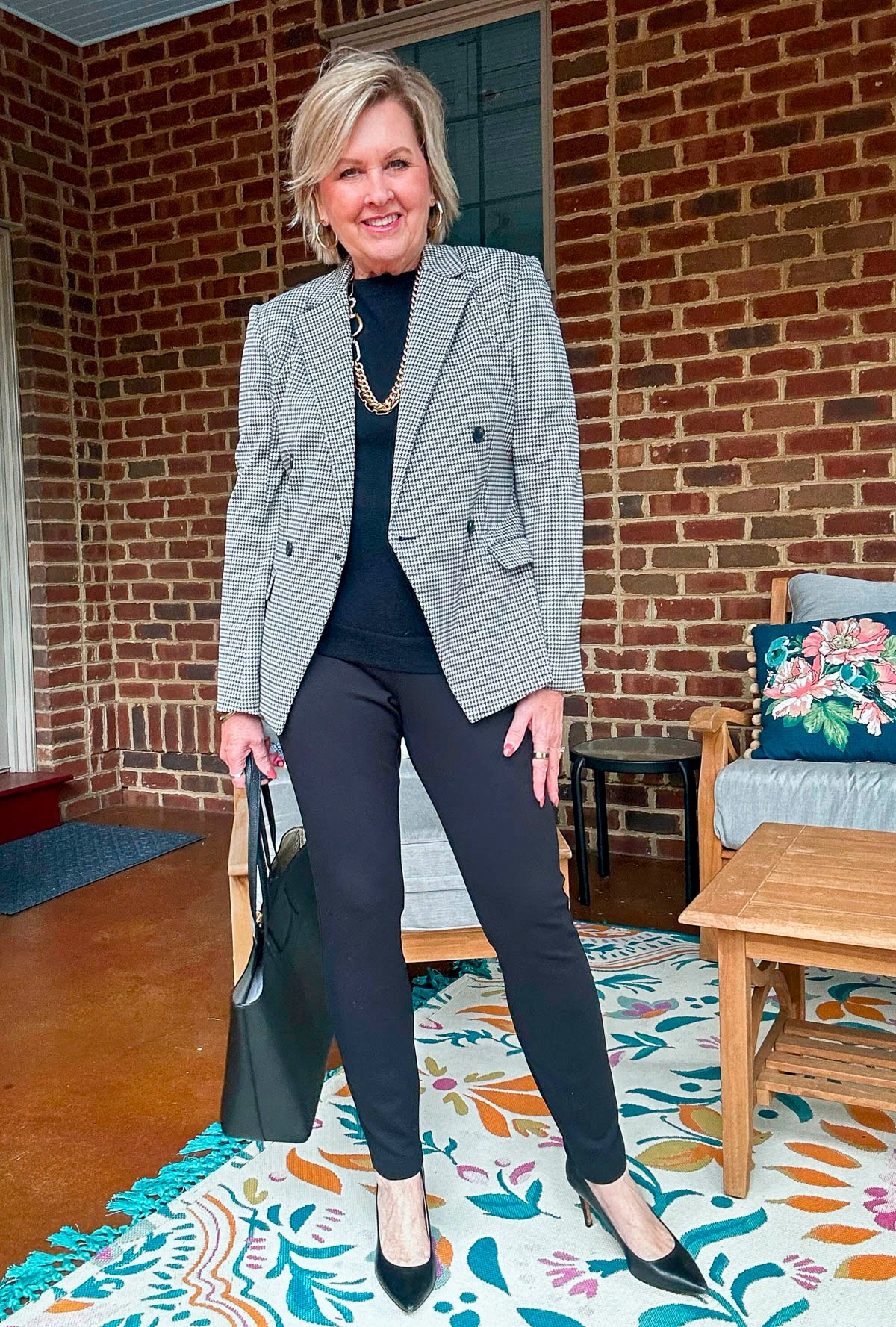 Tania Stephens wearing Ponte leggings with a black sweater and a check blazer