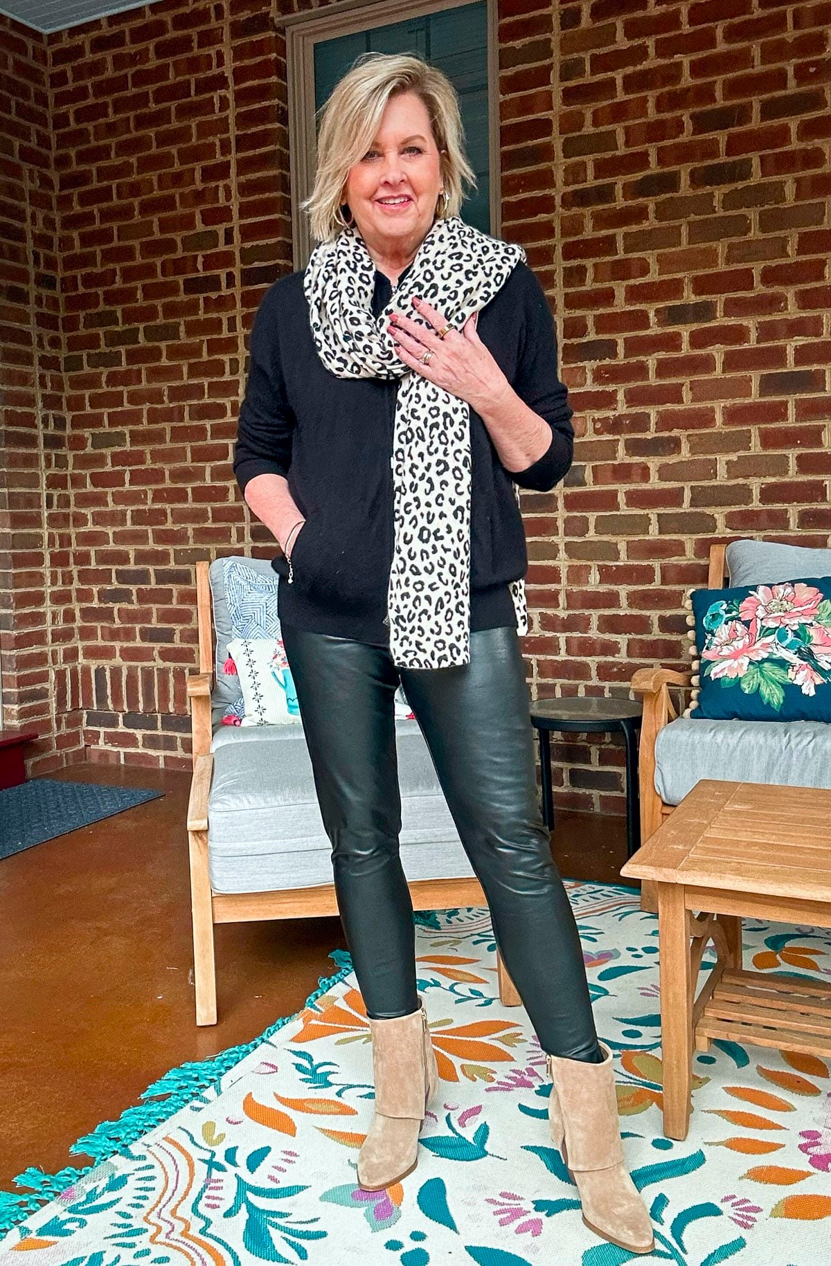 Tania Stephens wearing faux leather leggings with a black sweater and boots