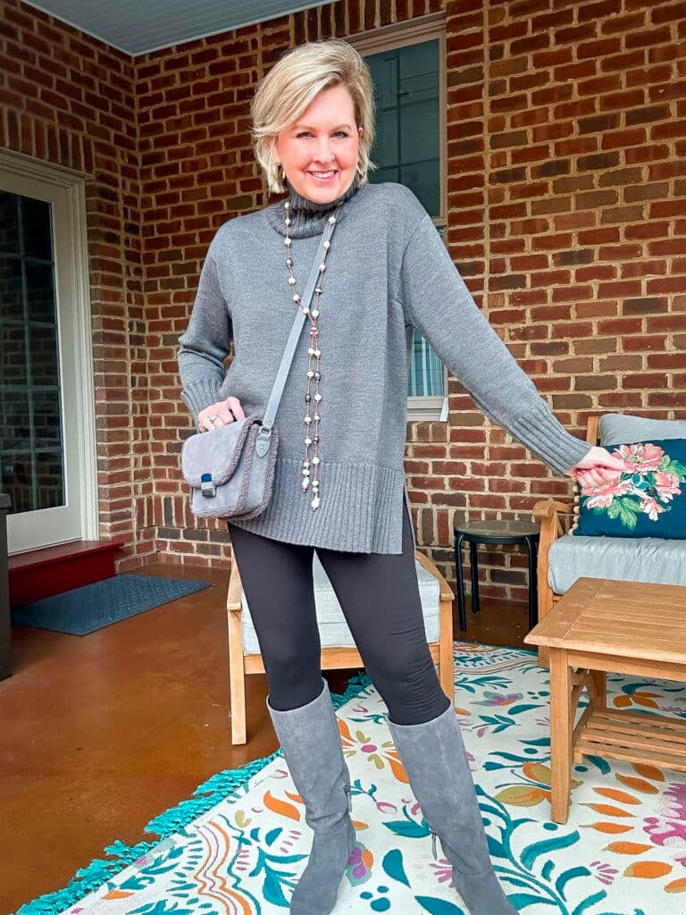 Tania Stephens wearing leggings with a gray poncho sweater