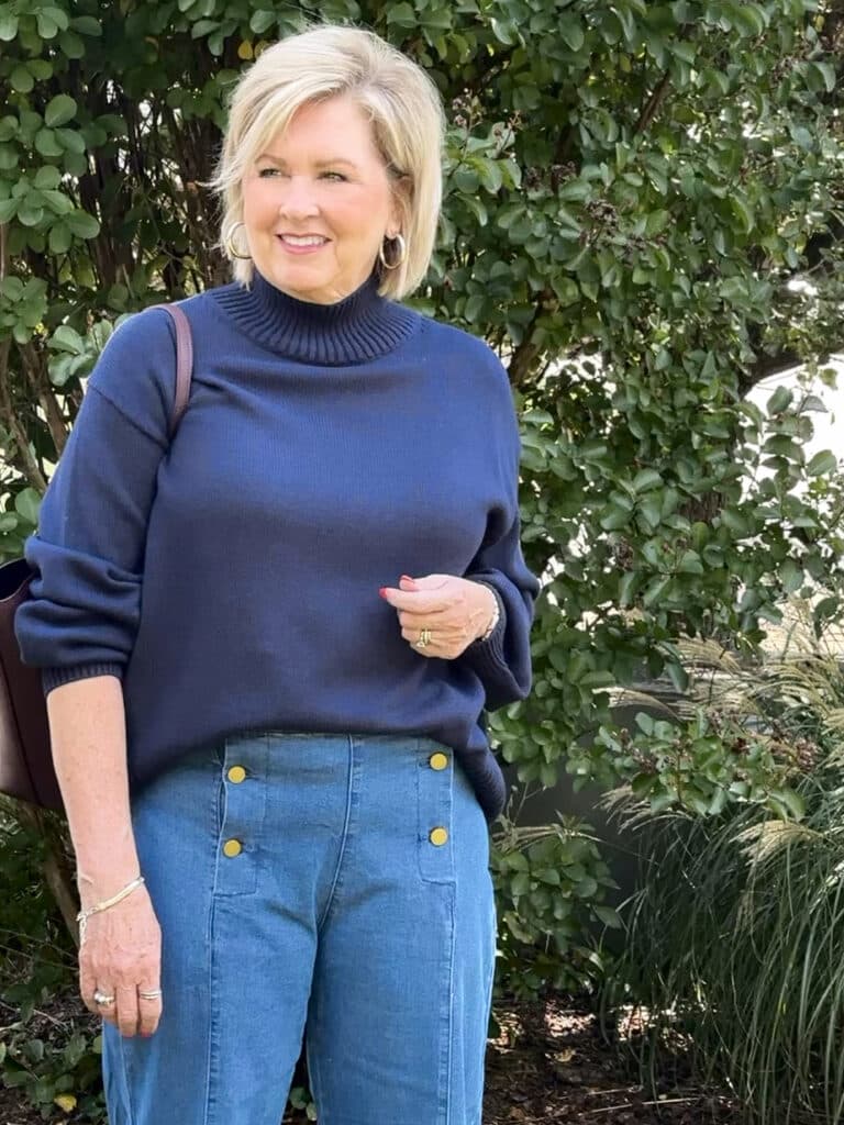 Tania Stephens wearing a navy funnel neck sweater