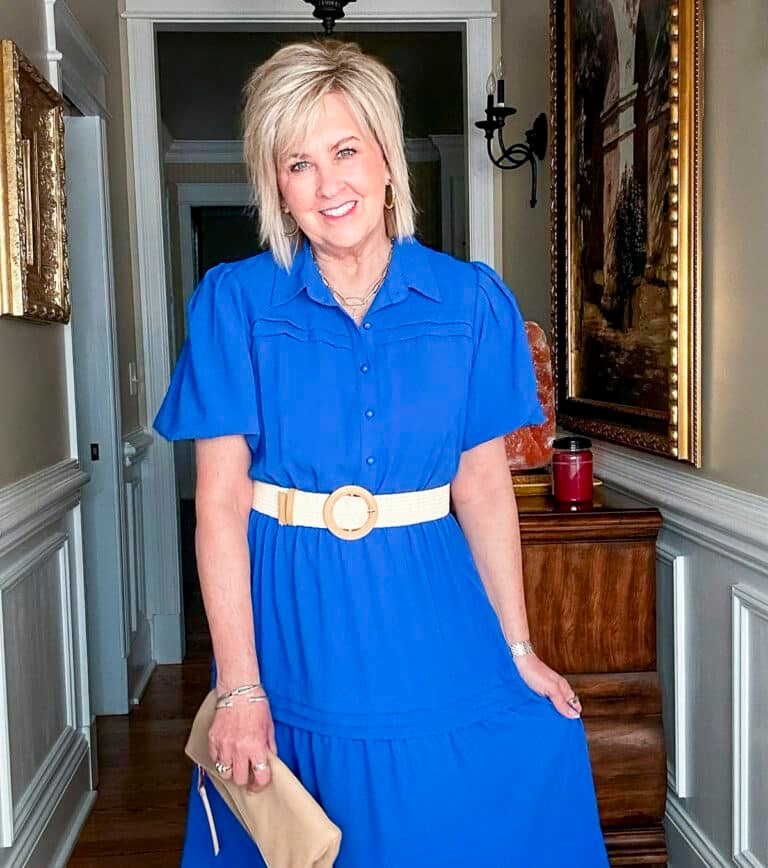 Over 50 Fashion Blogger, Tania Stephens is styling a blue dress with a woven belt from Amazon