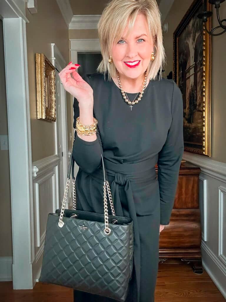 Over 50 Fashion Blogger, Tania Stephens is styling the mob wife look with a long black dress and a quilted black handbag