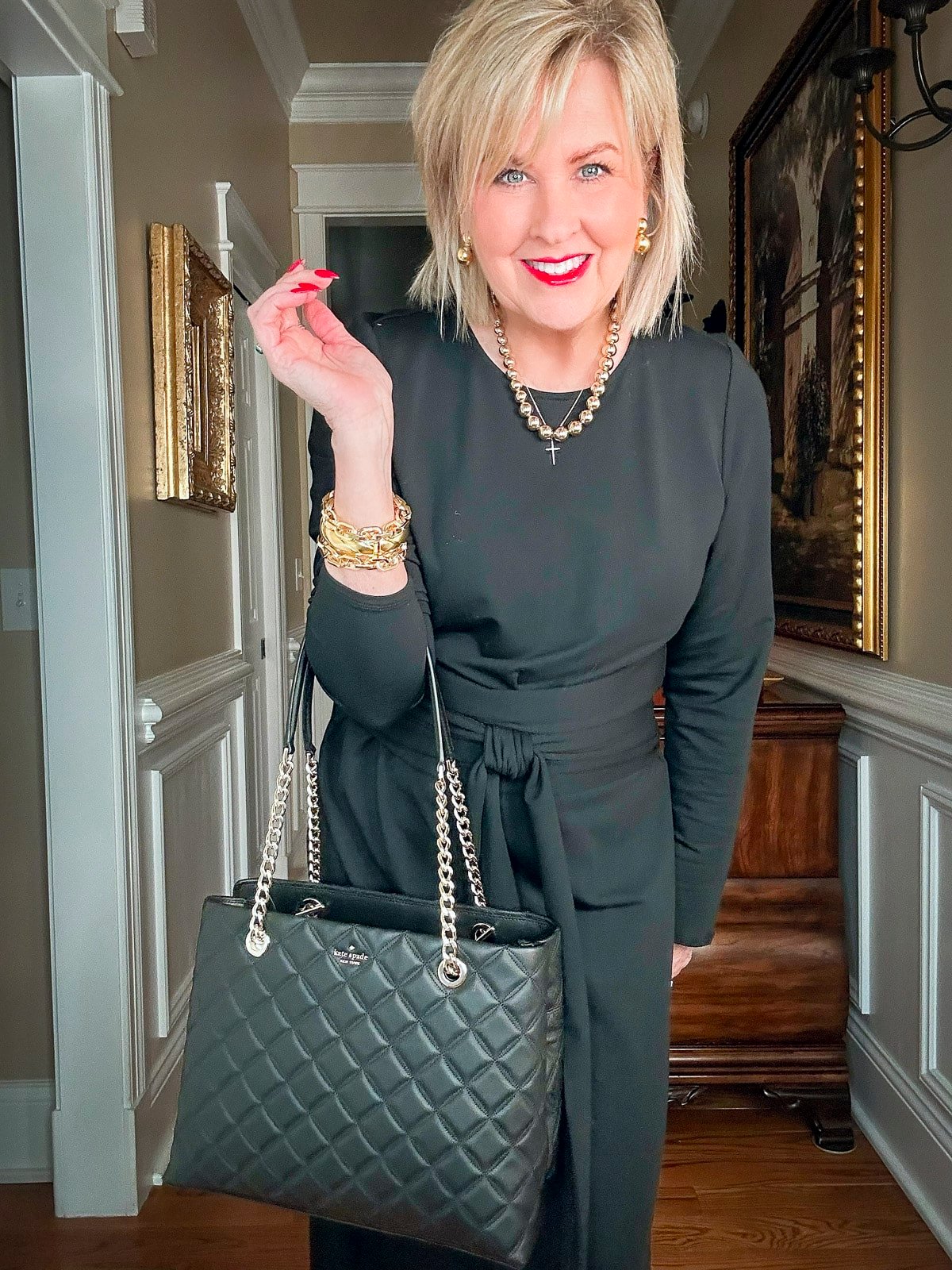 Over 50 Fashion Blogger, Tania Stephens is styling the mob wife look with a long black dress and a quilted black handbag