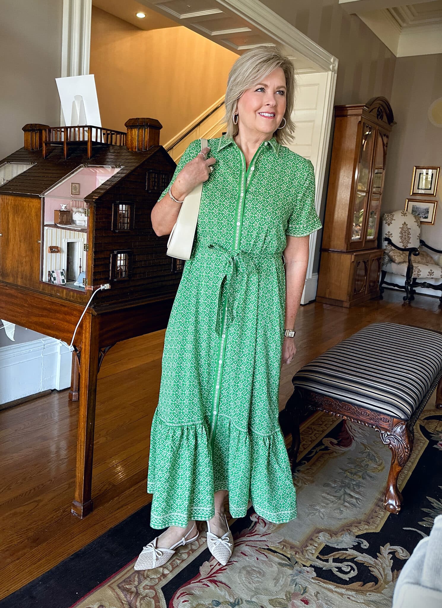 Tania Stephens is wearing a short sleeve green maxi spring wedding guest dress