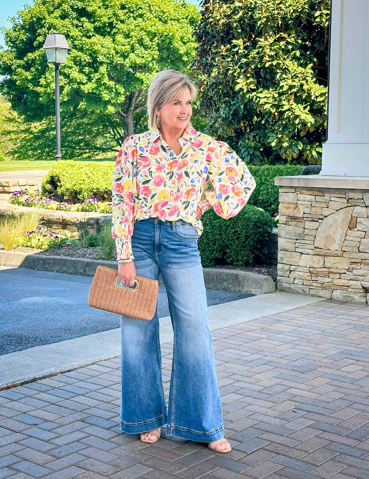 Over 50 Fashion Blogger, Tania Stephens is wearing a shirt with roses and wide leg jeans 2