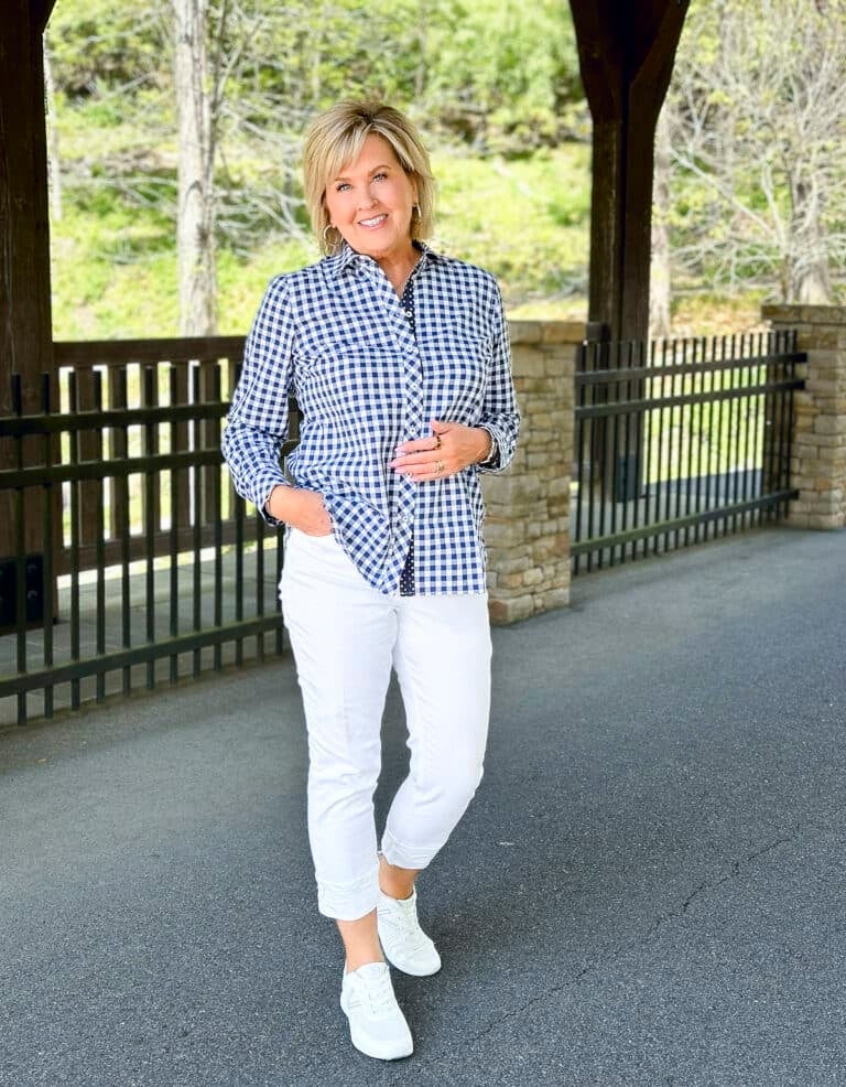 Over 50 Fashion Blogger, Tania Stephens is wearing a gingham check shirt with white cuffed jeans 3