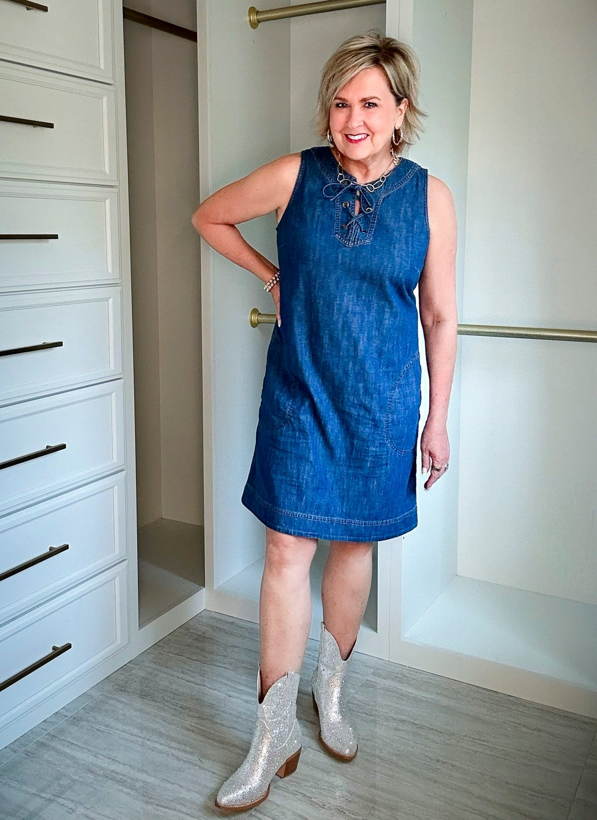 Over 50 Fashion Blogger, Tania Stephens is wearing a denim dress with a pair of brown boots4