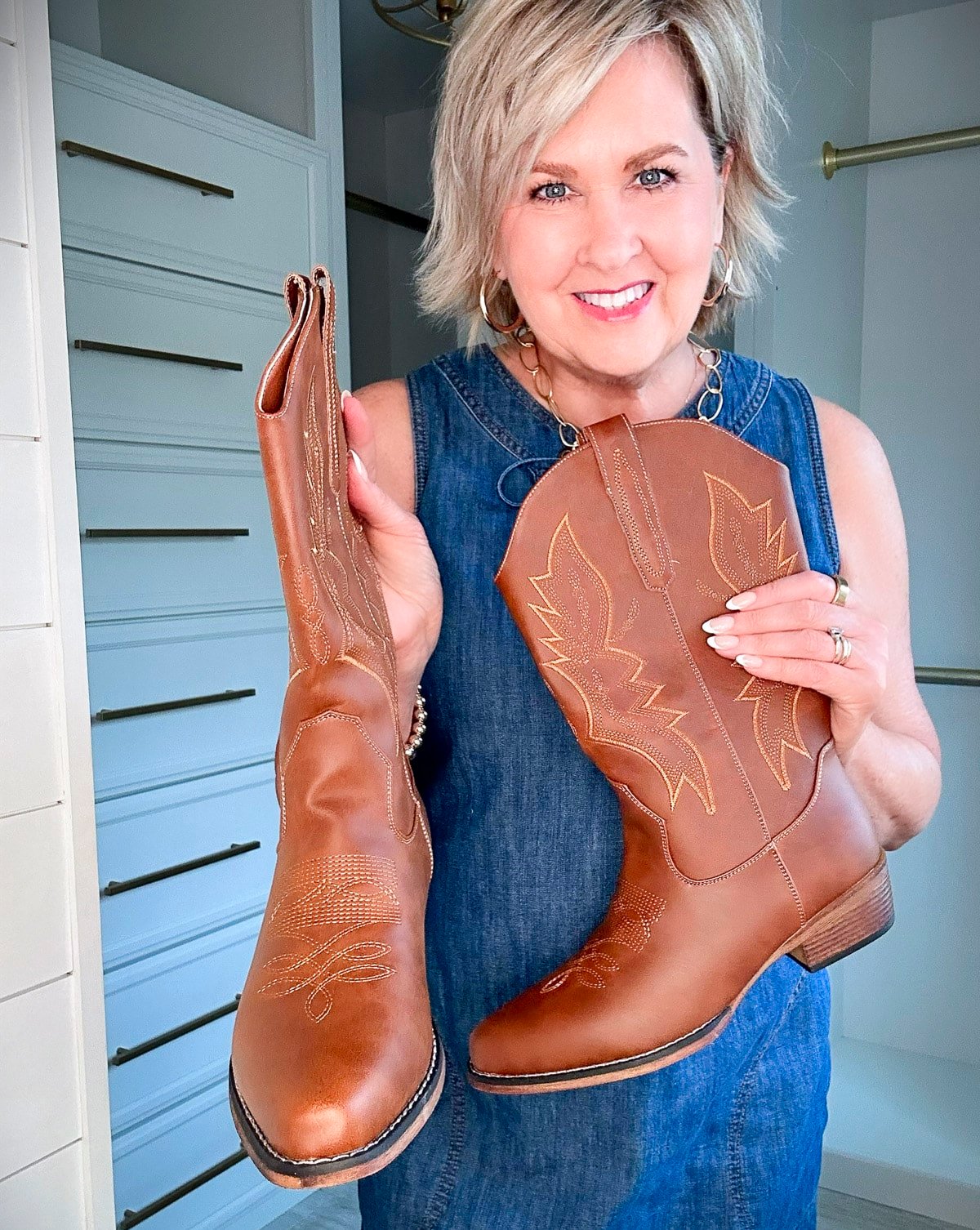 Over 50 Fashion Blogger, Tania Stephens is wearing a denim dress with a pair of brown boots7