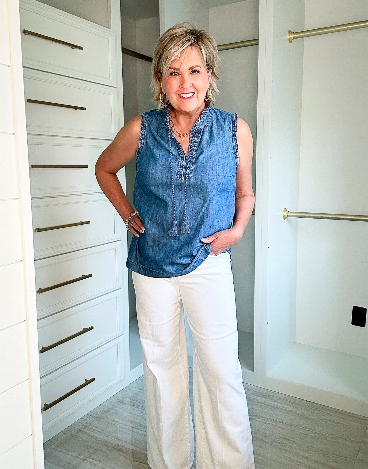 Over 50 Fashion Blogger, Tania Stephens is wearing a short sleeve denim shirt with a pair of wide leg jeans1
