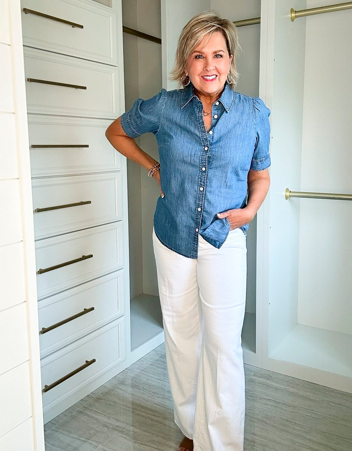 Over 50 Fashion Blogger, Tania Stephens is wearing a short sleeve denim shirt with a pair of wide leg jeans 3