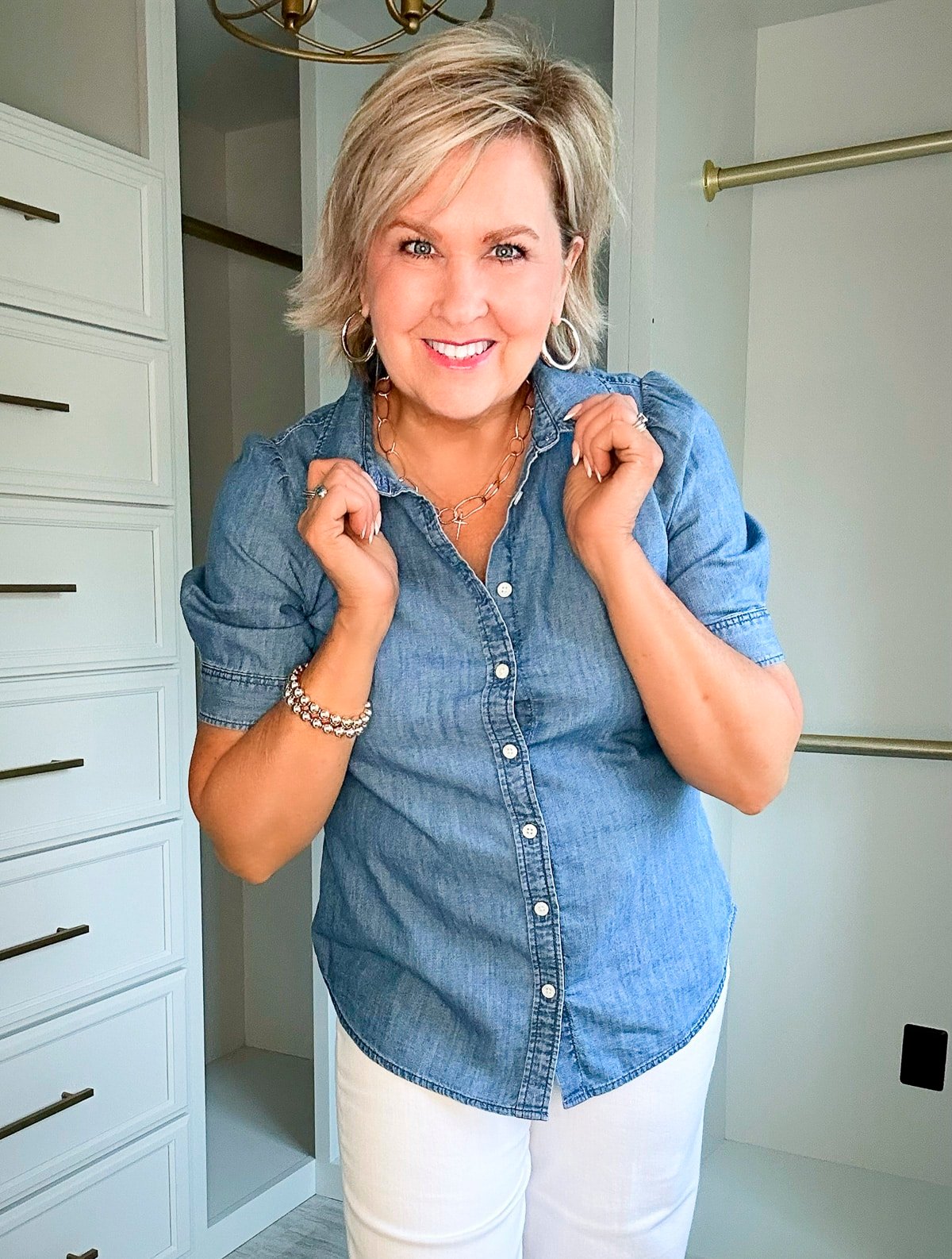 Over 50 Fashion Blogger, Tania Stephens is wearing a short sleeve denim shirt with a pair of wide leg jeans4