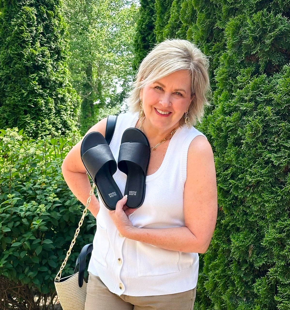 Over 50 Fashion Blogger, Tania Stephens is wearing Eileen Fisher shoes with beige pants and a white sweater vest1