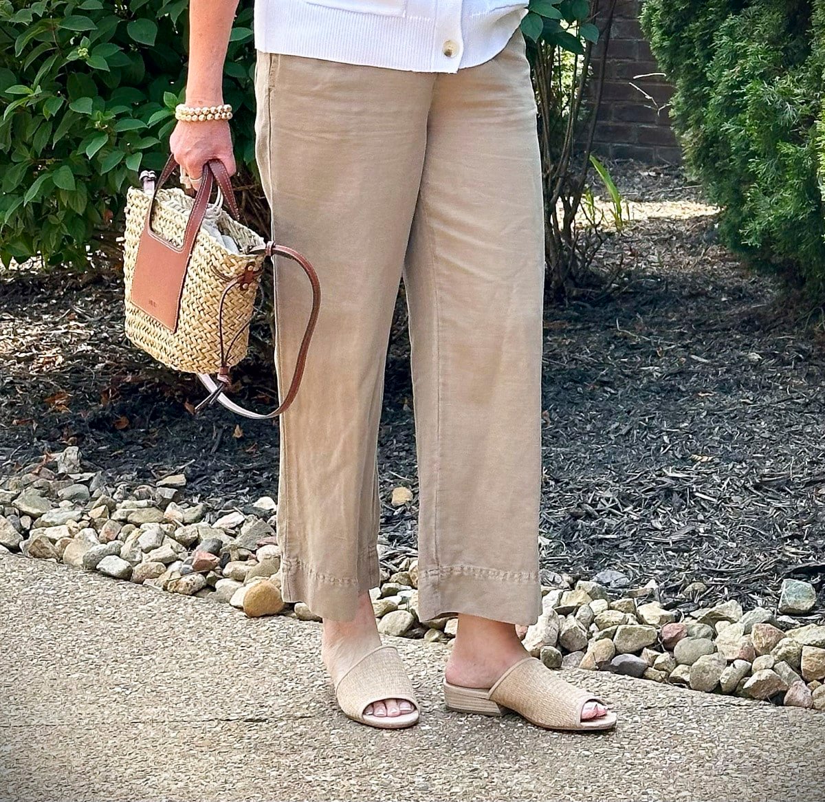 Over 50 Fashion Blogger, Tania Stephens is wearing Eileen Fisher shoes with beige pants and a white sweater vest2