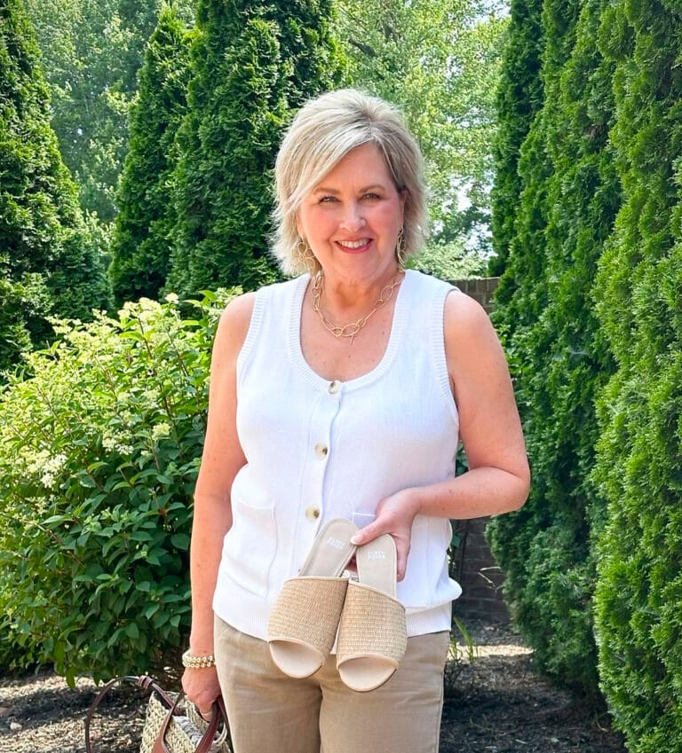 Over 50 Fashion Blogger, Tania Stephens is wearing Eileen Fisher shoes with beige pants and a white sweater vest3