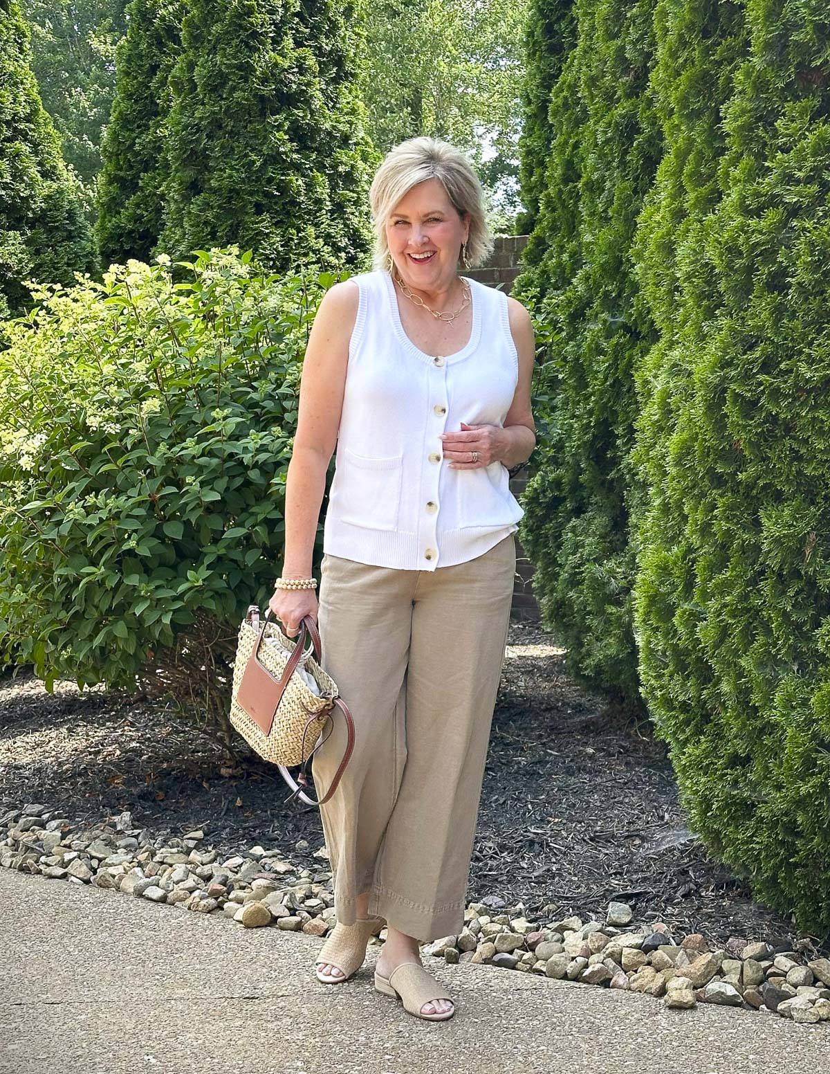 Over 50 Fashion Blogger, Tania Stephens is wearing Eileen Fisher shoes with beige pants and a white sweater vest 4